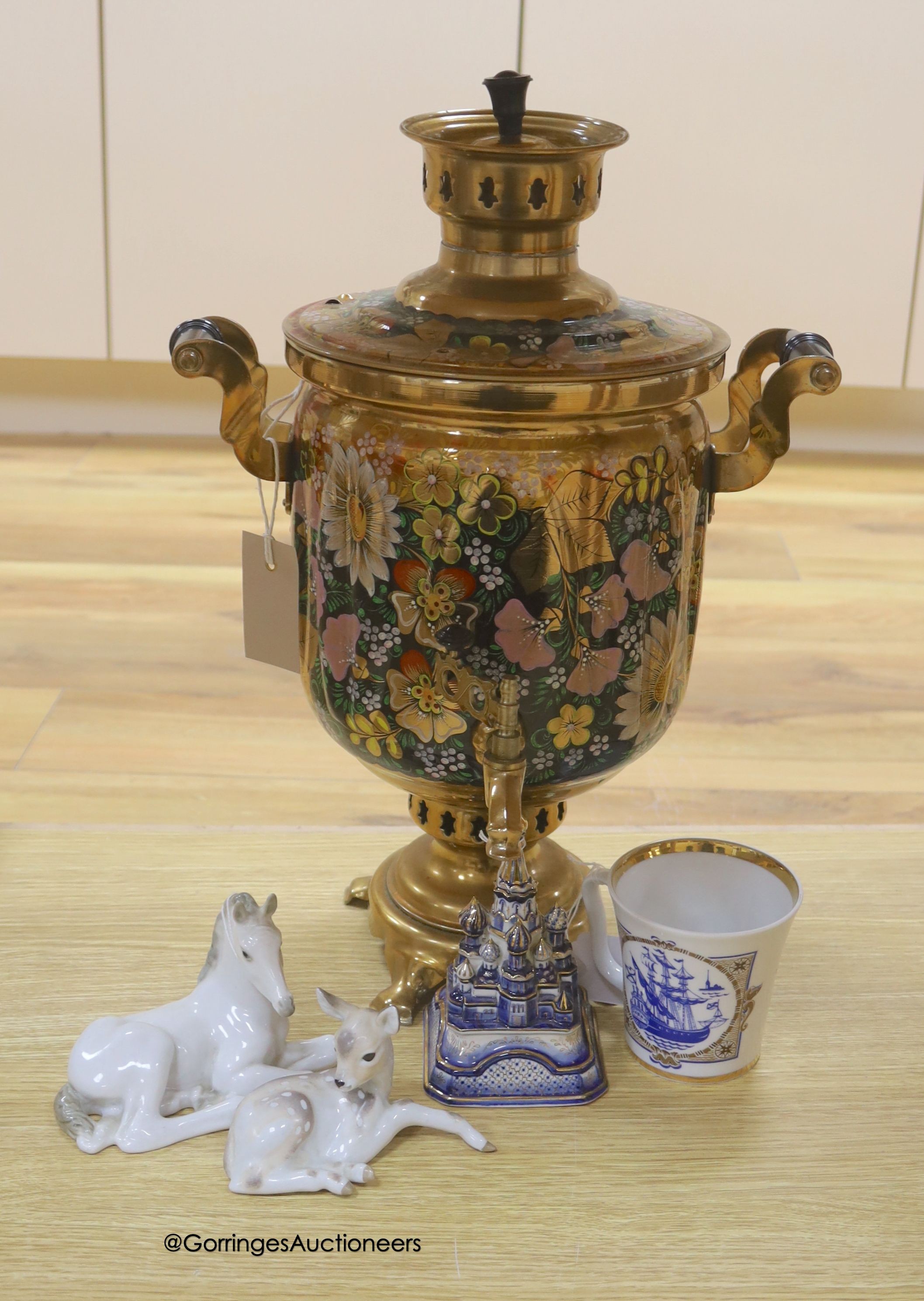 A Russian gilt samovar painted with flowers and a small collection of Russian ceramics